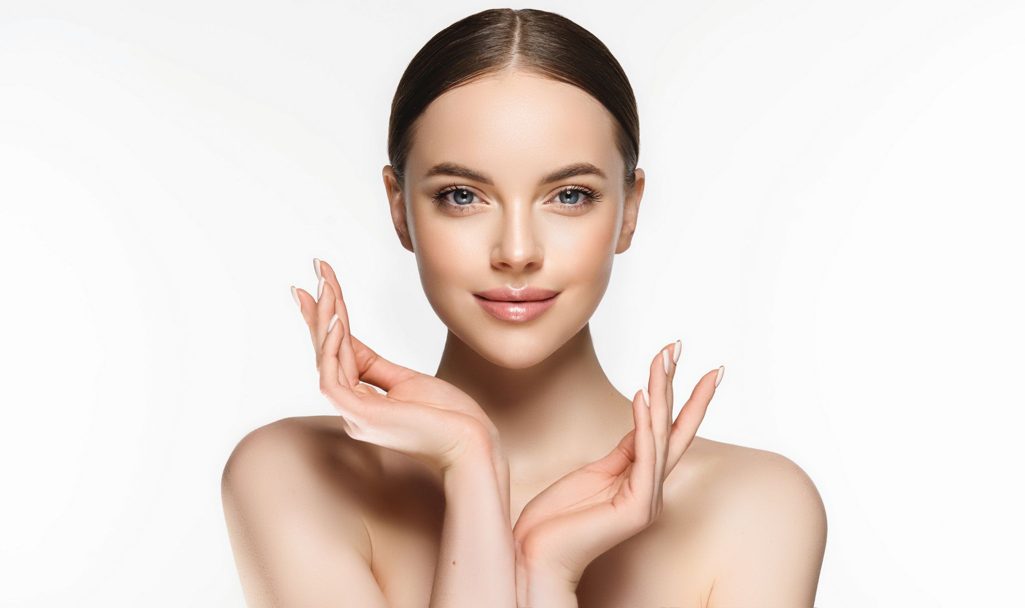 Beautiful Young Woman with Clean Fresh Skin . Facial treatment . Cosmetology , beauty and spa . Nice and attractive girl with a pleasant smile.
